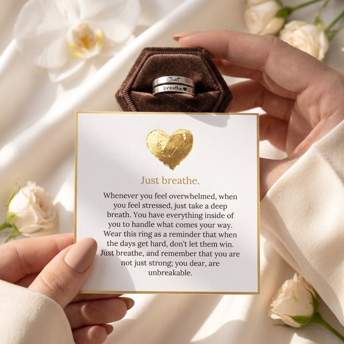 Silver-tone open wrap ring with Just breathe and heart engraving beside the included encouragement message card