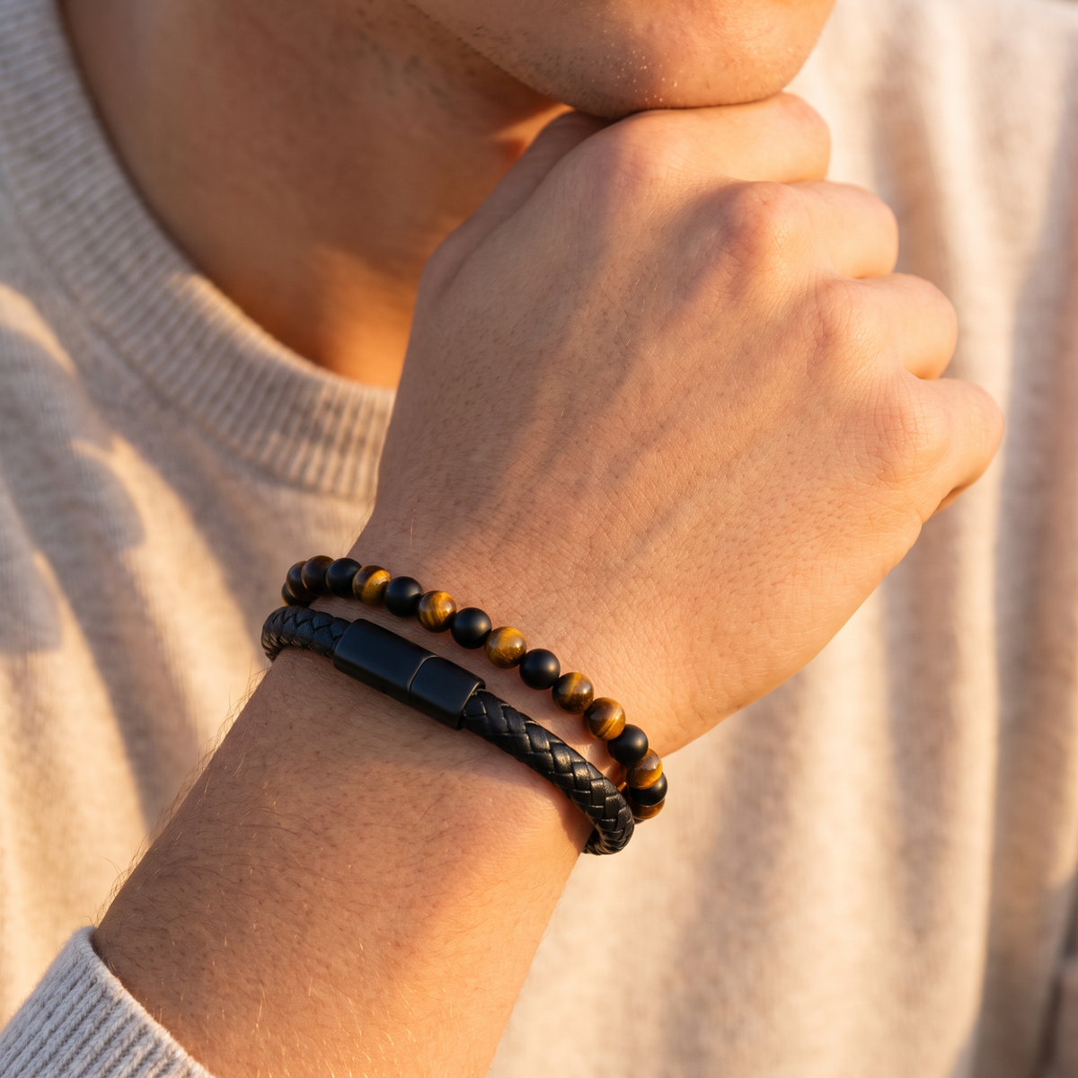 Bracelet worn on a son's wrist with a cream sweater