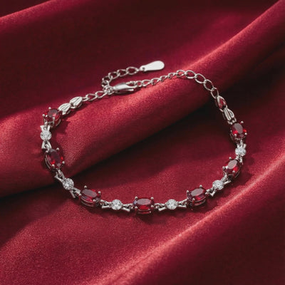 The Vivara Oval Simulated Ruby Tennis Bracelet in solid gold.