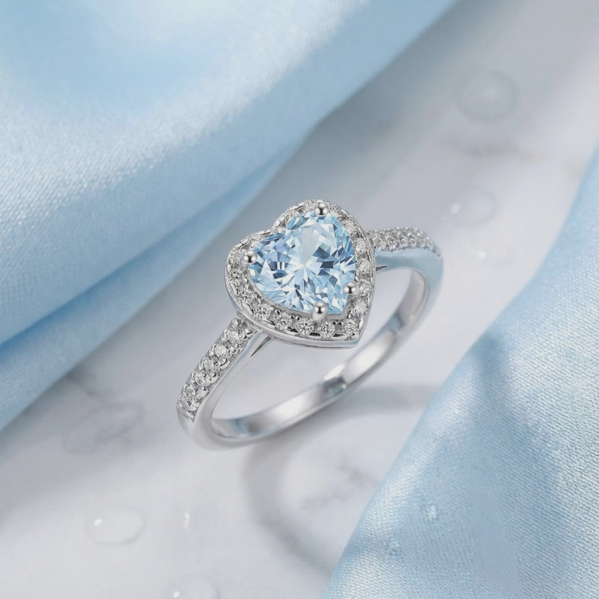 Simulated aquamarine heart halo ring in solid gold.