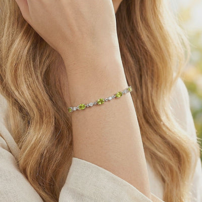 A video showcasing the oval simulated peridot tennis bracelet crafted in solid gold.