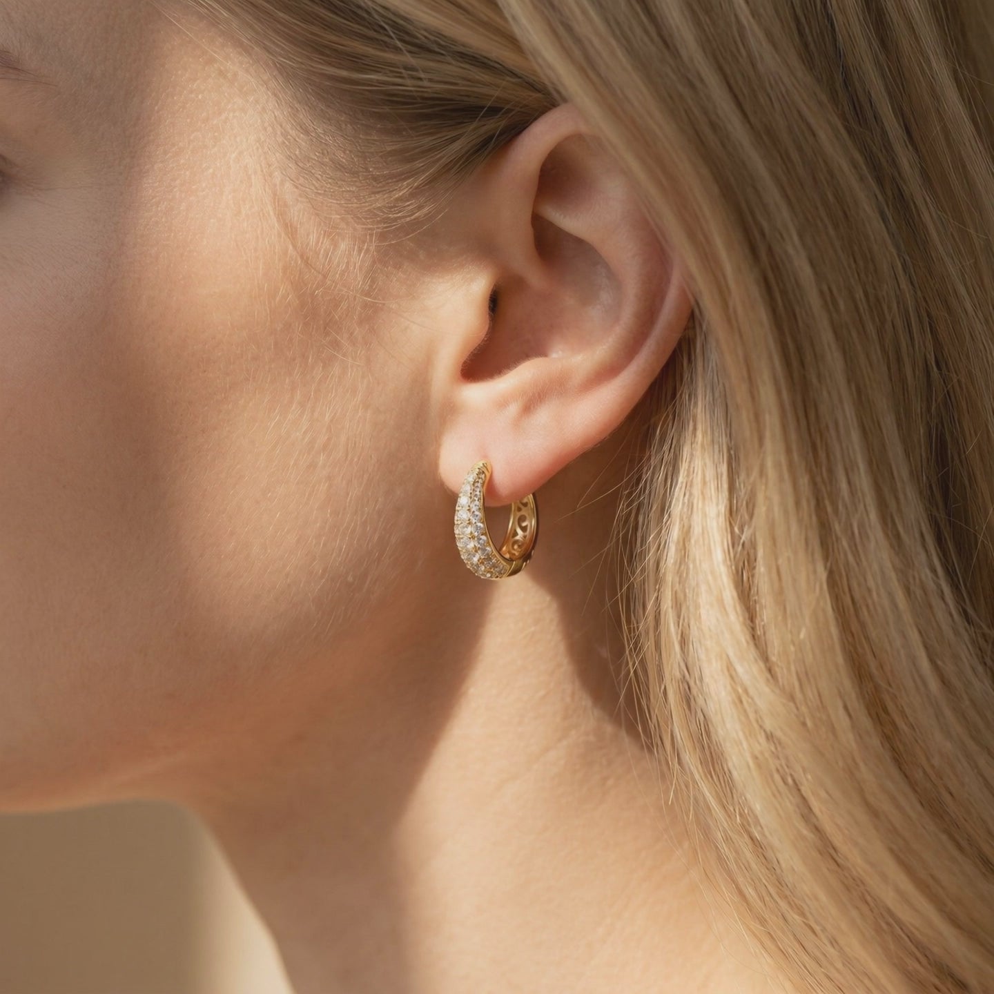 Corabelle moissanite J-hoop earrings in solid gold.