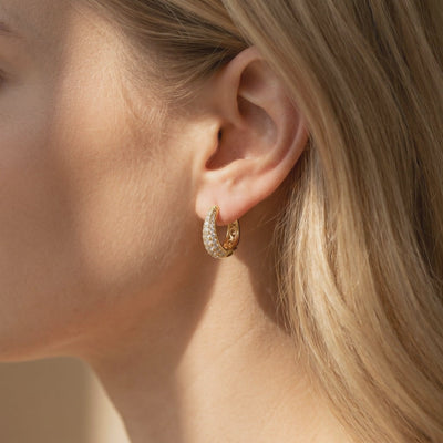 Corabelle moissanite J-hoop earrings in solid gold.