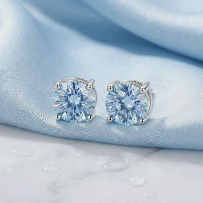 Simulated aquamarine stud earrings in solid gold.