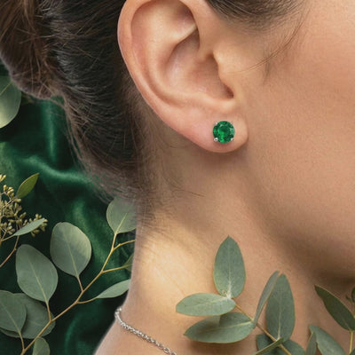 Simulated emerald stud earrings in solid gold.
