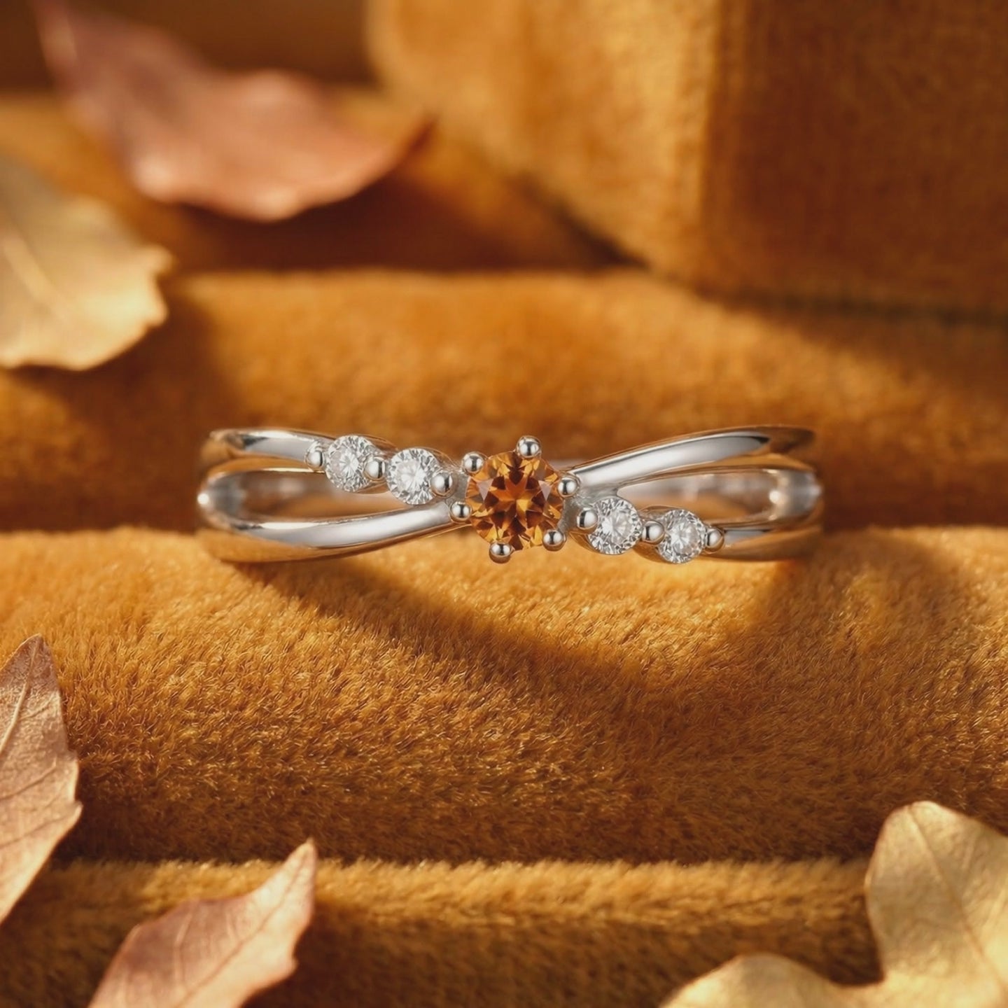 Solid white gold crossover ring featuring a simulated topaz.