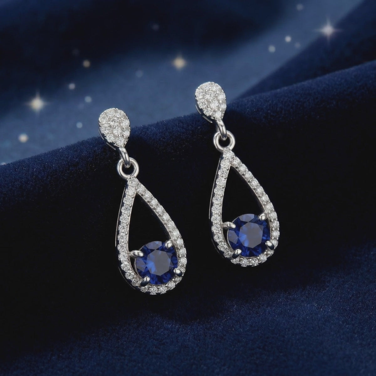 Teardrop earrings with simulated sapphires in solid gold.