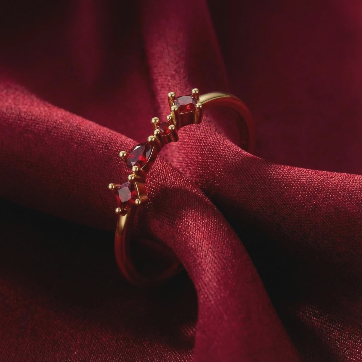 The Julianna cluster ring in solid gold with simulated rubies.