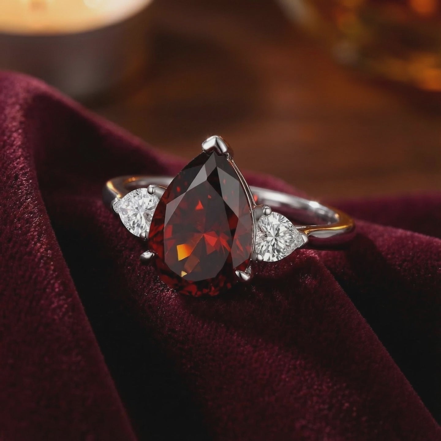 A solid gold ring with a pear-shaped simulated garnet.