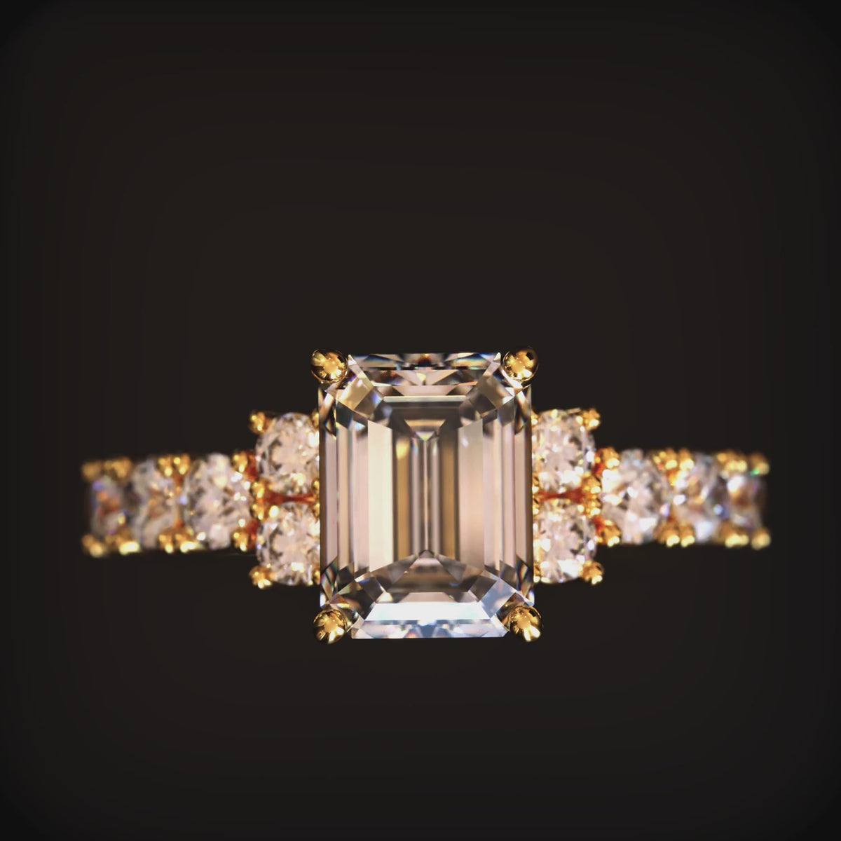 A solid gold ring with an emerald-cut moissanite center stone.
