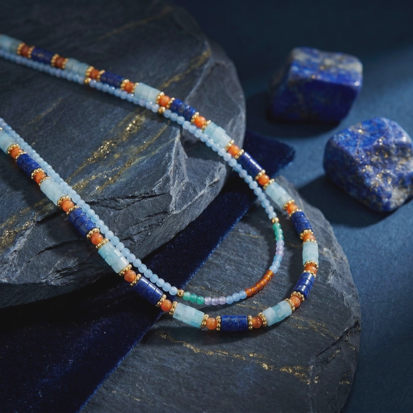 Layered solid gold necklace with natural lapis lazuli beads.