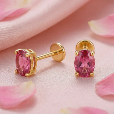 Precision oval cut simulated pink tourmaline stud earrings crafted in solid gold.