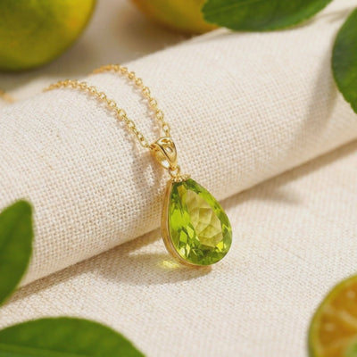 Teardrop simulated peridot pendant necklace in solid gold.