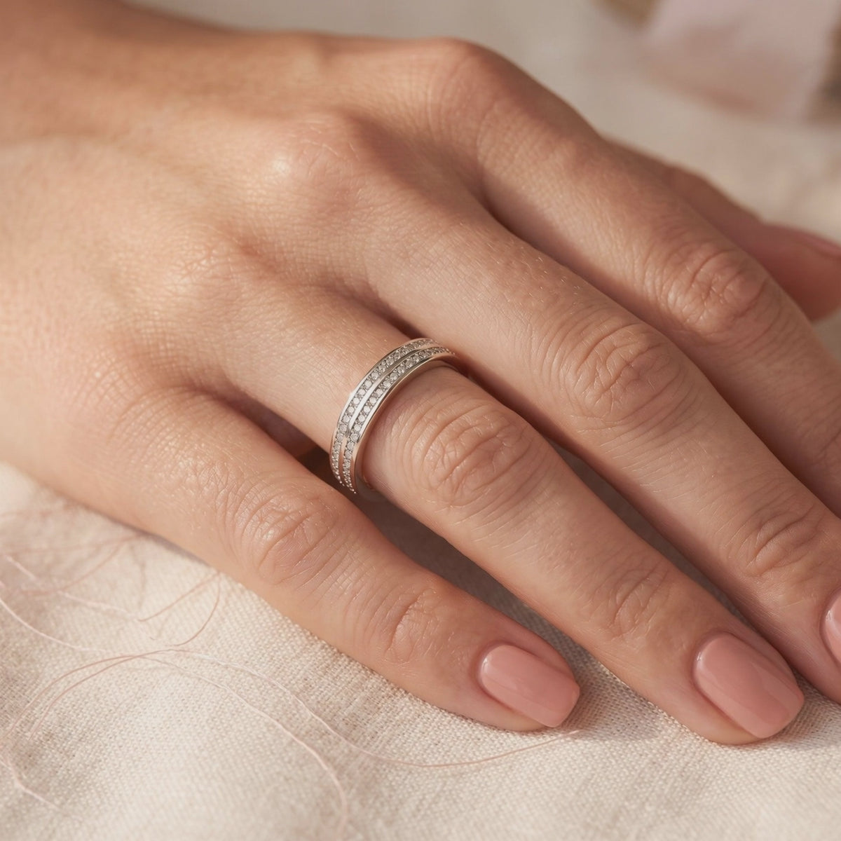 The Margaux double-row pavé sterling silver ring with clear stones, shown worn on a hand.