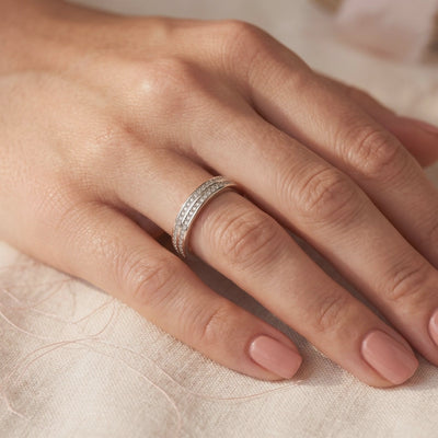 The Margaux double-row pavé sterling silver ring with clear stones, shown worn on a hand.