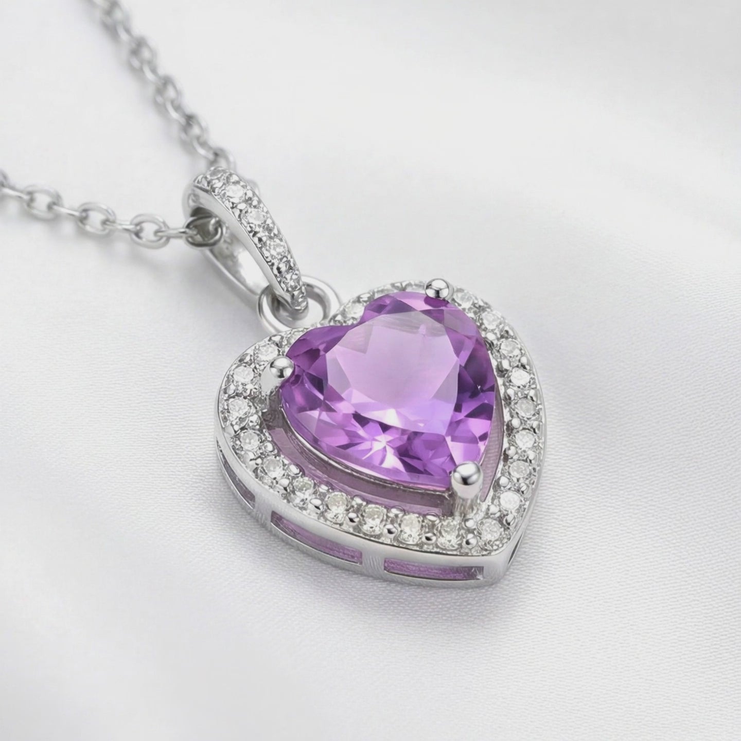 A solid gold pendant necklace with a simulated amethyst.