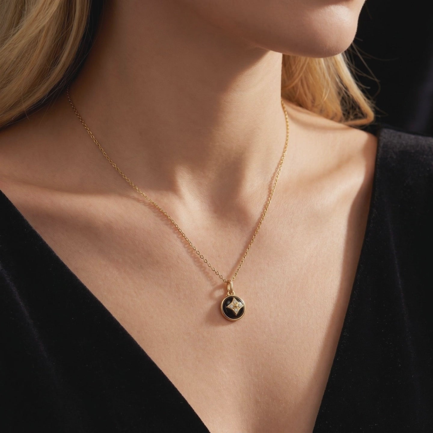A 14K and 18K solid gold necklace featuring a natural black onyx pendant.