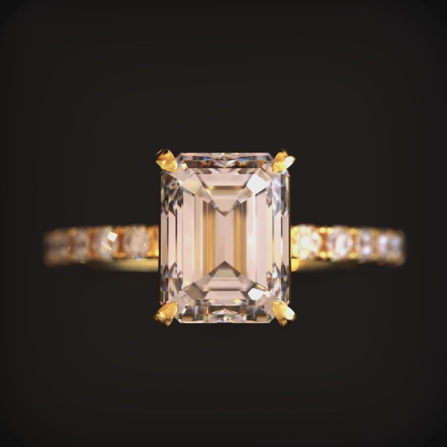 A solid gold ring with a 2CT emerald-cut moissanite gemstone.