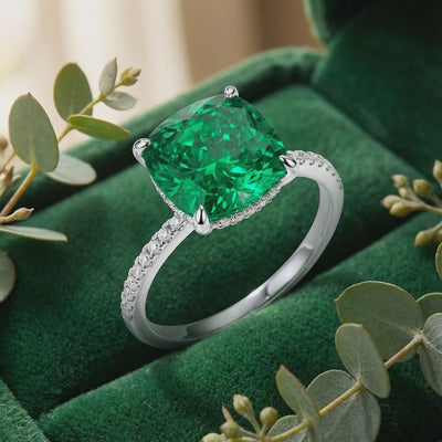 Solid gold ring with cushion-cut simulated emerald.