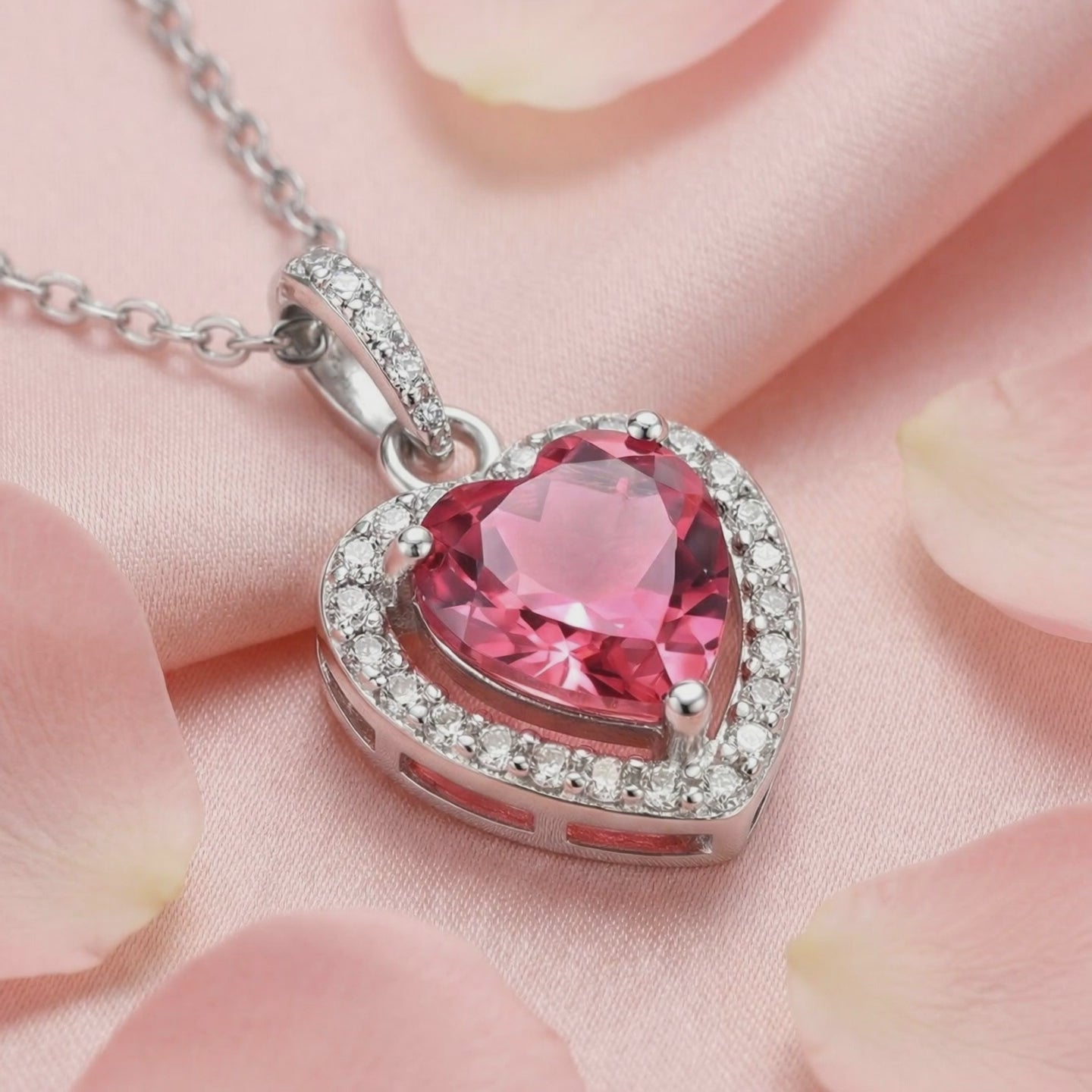 A solid gold necklace with a heart-cut simulated pink tourmaline pendant.