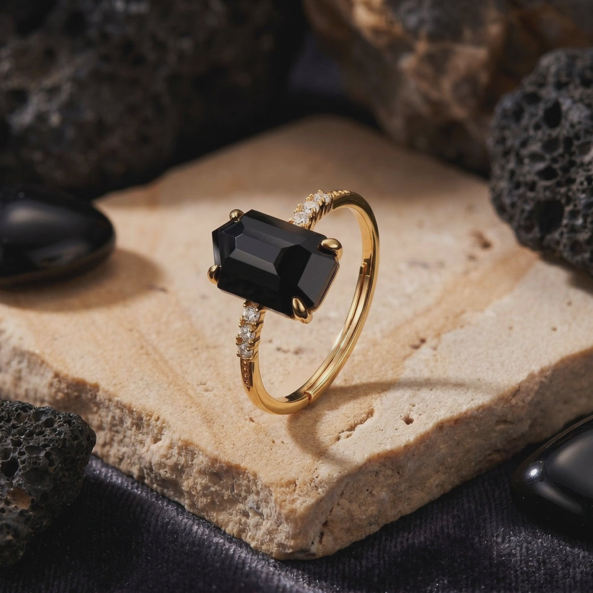 Detailed view of the Noctura solid gold ring with an irregular-cut natural black onyx.