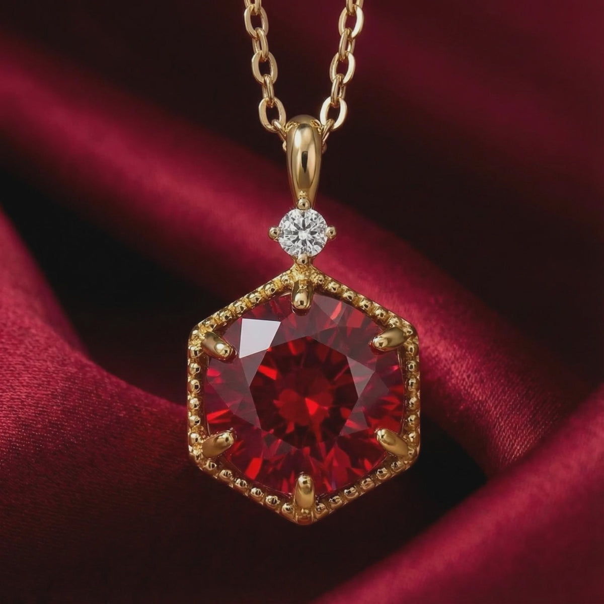 Solid gold necklace with hexagonal simulated ruby pendant.