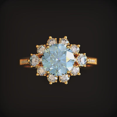 A blue moissanite halo ring in solid gold.