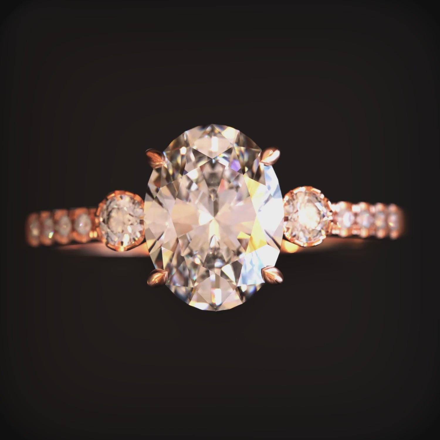 A ring with an oval moissanite stone and solid gold material.