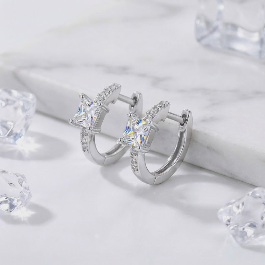 Princess-cut simulated diamond huggie earrings crafted in solid gold.
