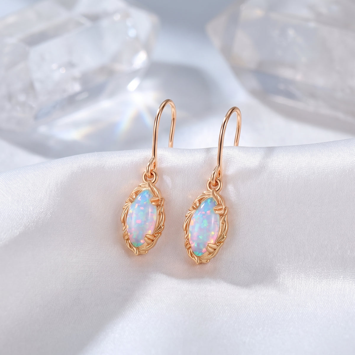 Rose gold mariquesa-cut white opal drop earrings.