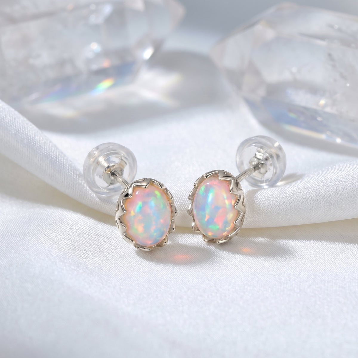 The Novalie Oval Opal stud earrings in a solid white gold setting.