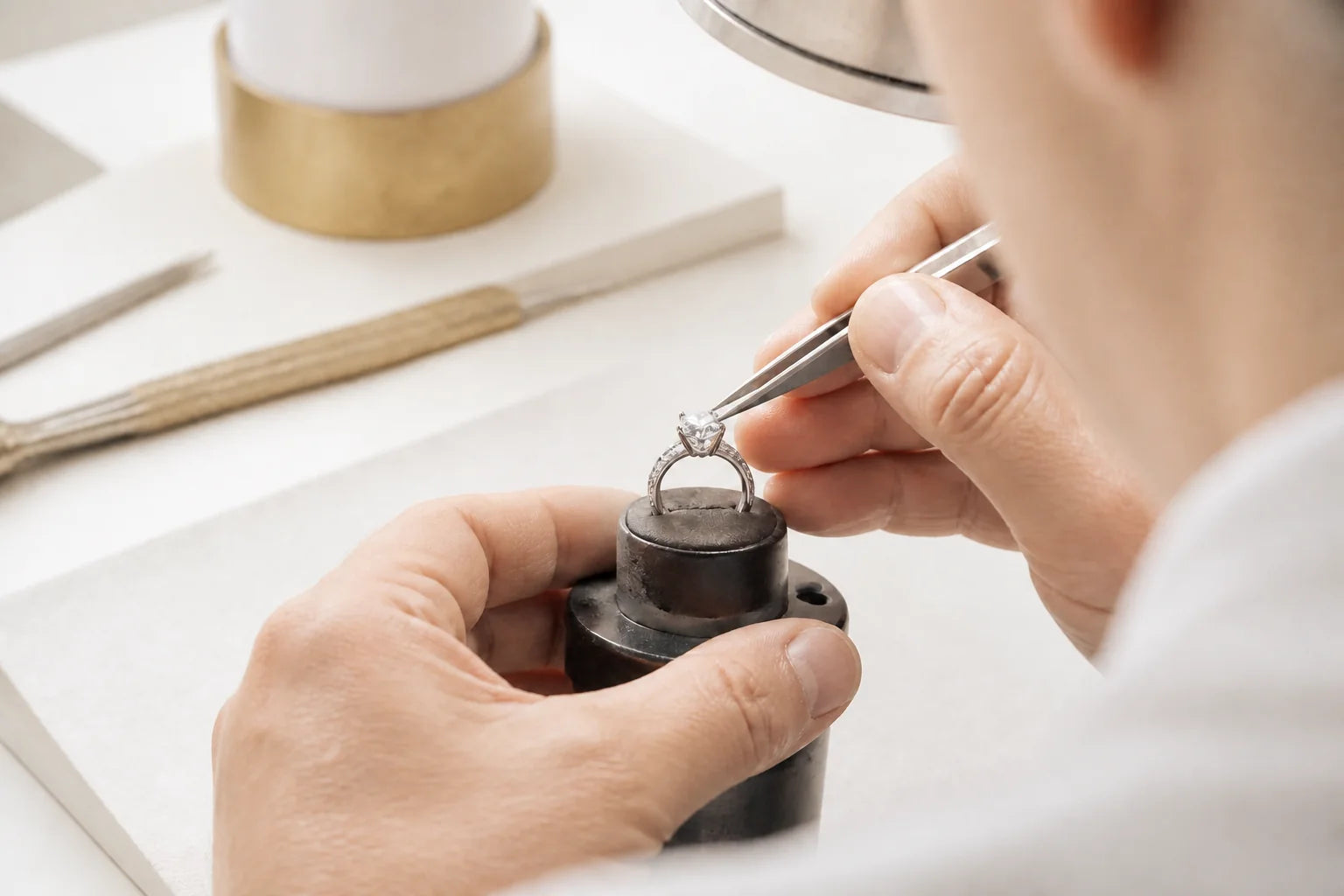 Master jeweler setting a custom engagement ring at the bench