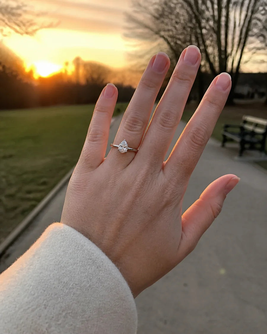 Pear-cut fine-jewelry ring worn during a sunset walk