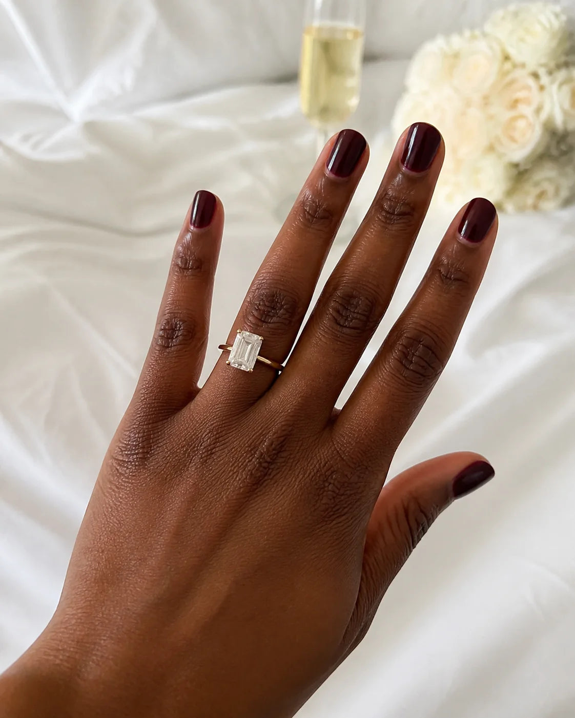 Emerald-cut fine-jewelry ring photographed in warm window light